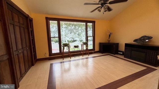 sitting room featuring light hardwood / wood-style flooring, vaulted ceiling, and ceiling fan