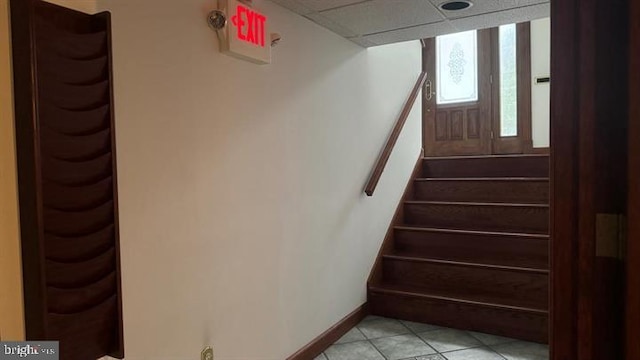 stairway with tile patterned floors