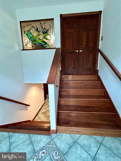 staircase featuring tile patterned flooring