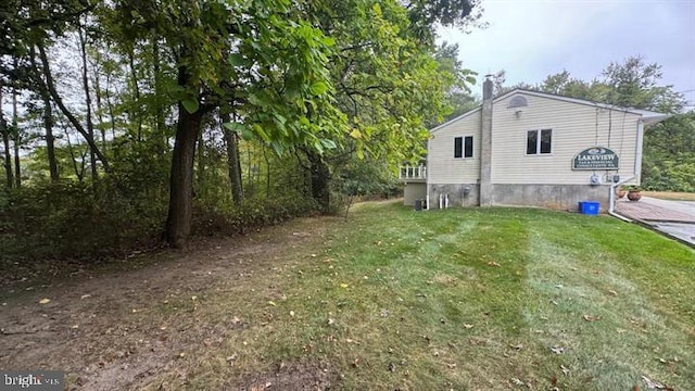 view of side of home featuring a lawn