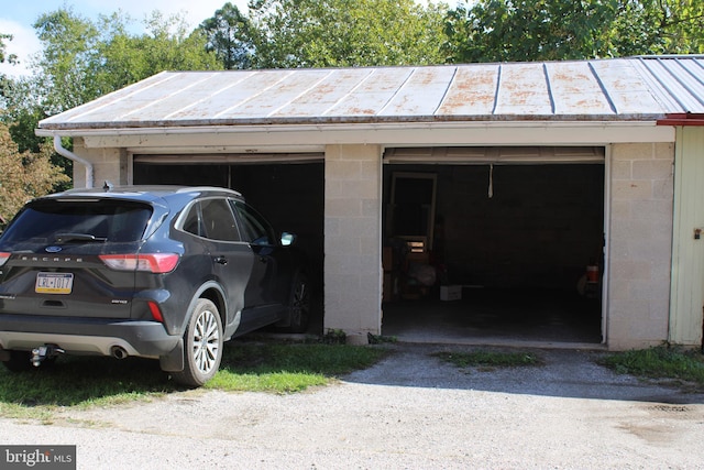 view of parking / parking lot featuring a garage