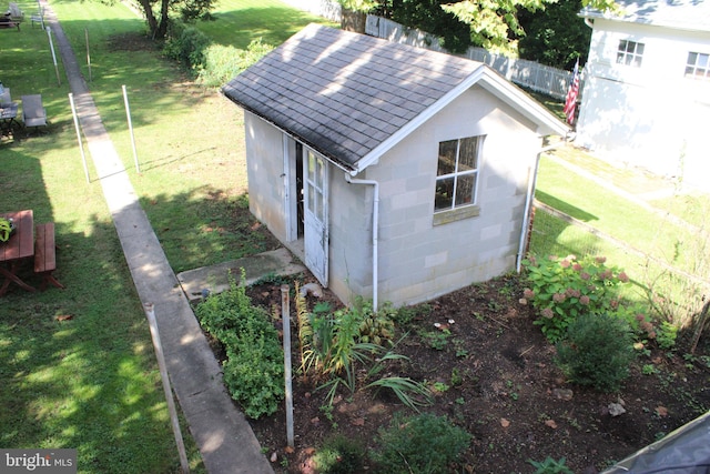 view of outbuilding featuring a lawn