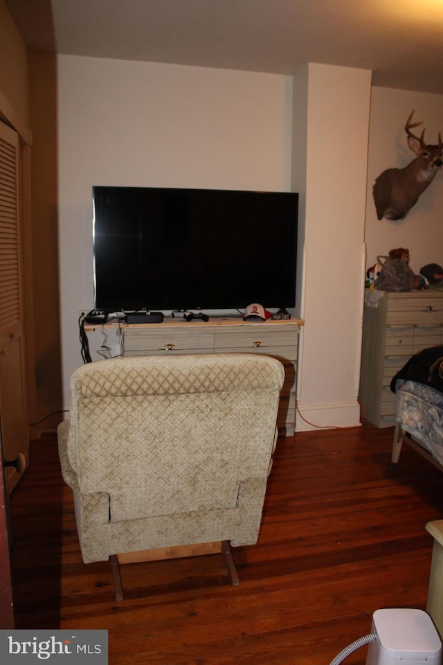 bedroom with dark hardwood / wood-style floors