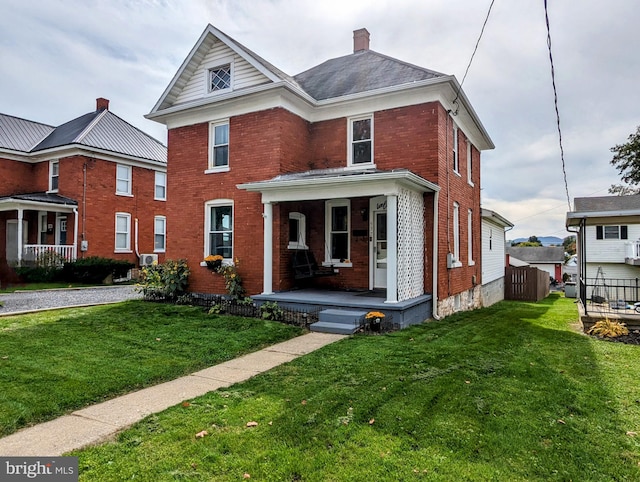 view of front facade featuring a front lawn and covered porch