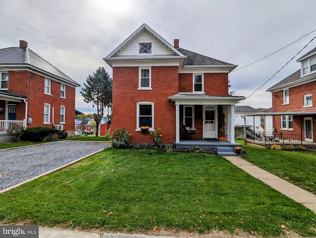 view of property featuring a front lawn and covered porch