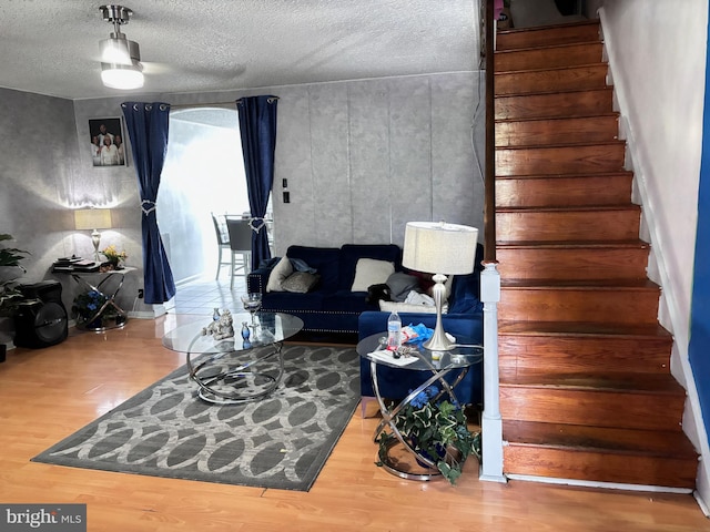 living room with a textured ceiling and hardwood / wood-style flooring