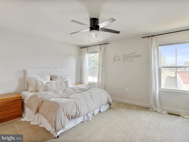 bedroom featuring light carpet and ceiling fan