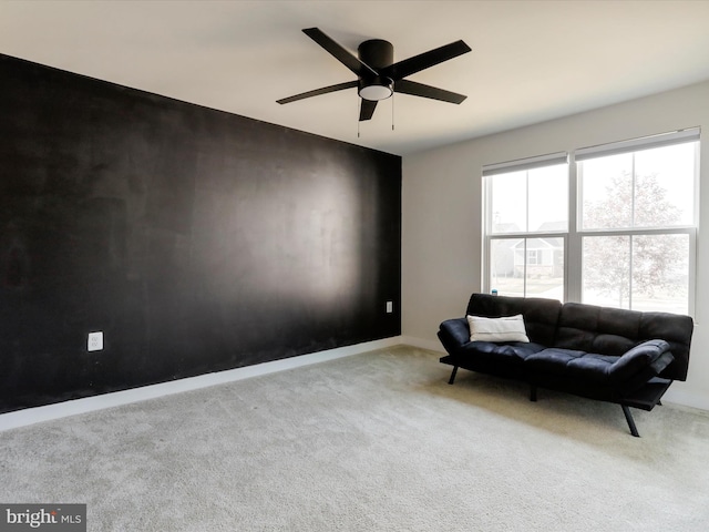 living area featuring ceiling fan and light colored carpet