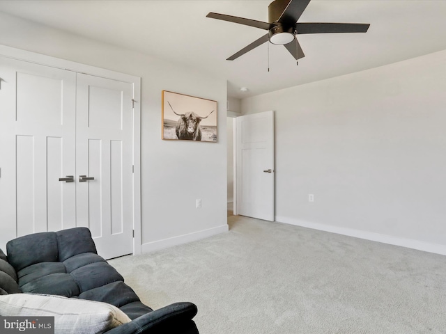 sitting room featuring ceiling fan and light colored carpet