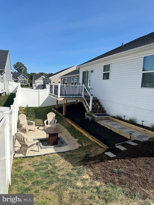 view of yard with a patio area, a deck, and a fire pit