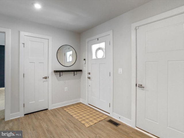 foyer entrance with light hardwood / wood-style floors