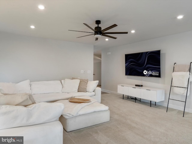 carpeted living room with ceiling fan