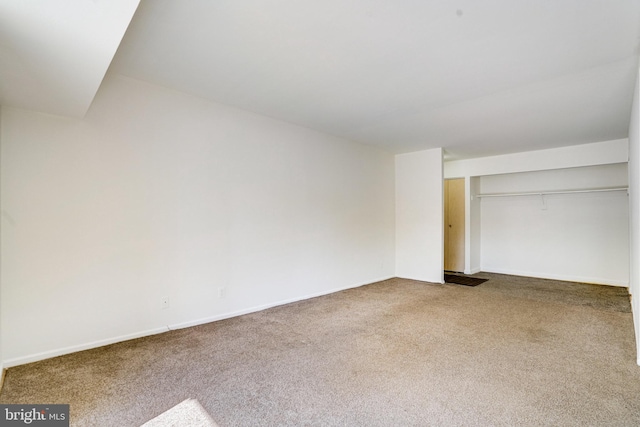 unfurnished bedroom with a closet and carpet