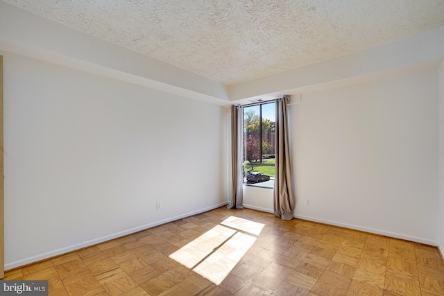 empty room featuring a textured ceiling