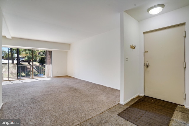 entryway with carpet and beamed ceiling