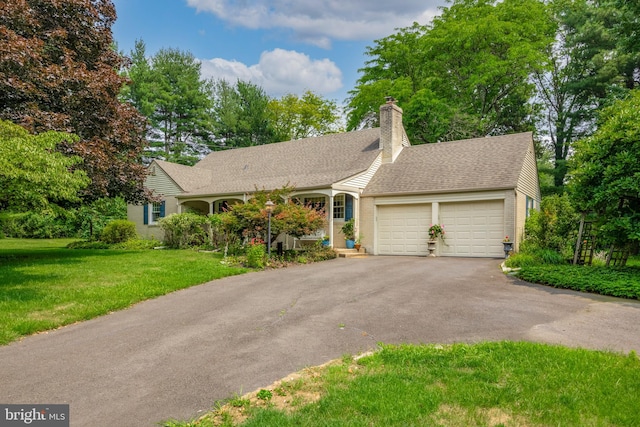 view of front of house with a garage and a front yard