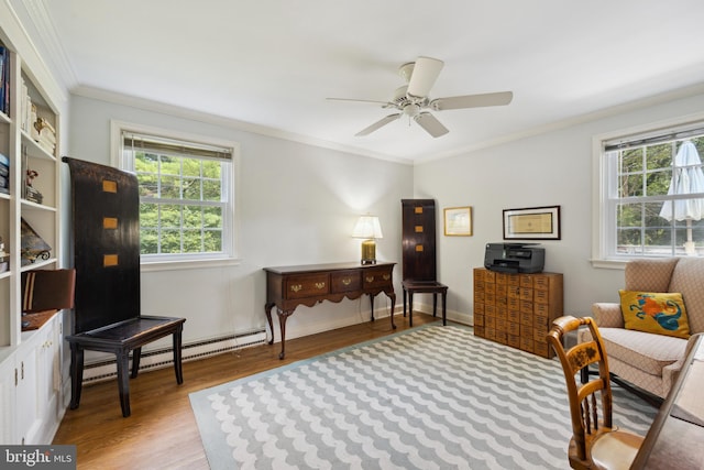 sitting room featuring light wood-type flooring, a healthy amount of sunlight, ornamental molding, and ceiling fan