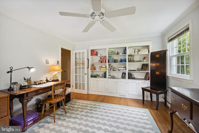 home office with light hardwood / wood-style floors, ornamental molding, and ceiling fan