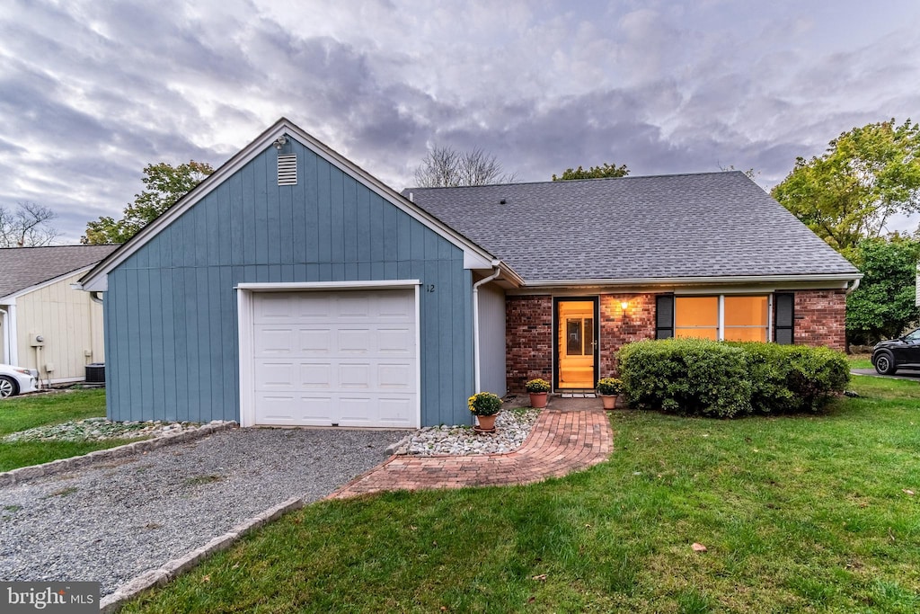 ranch-style home featuring a front yard and a garage