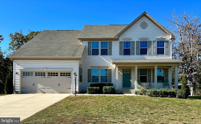 view of front of property featuring a front lawn, covered porch, and a garage