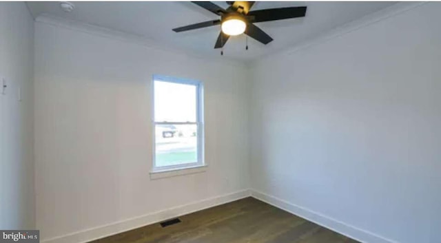 spare room with ornamental molding, ceiling fan, and dark wood-type flooring