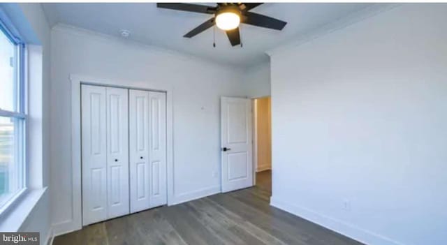 unfurnished bedroom with a closet, dark hardwood / wood-style floors, ornamental molding, and ceiling fan