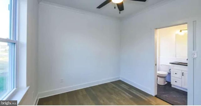 unfurnished bedroom with ornamental molding, ceiling fan, connected bathroom, and dark hardwood / wood-style flooring