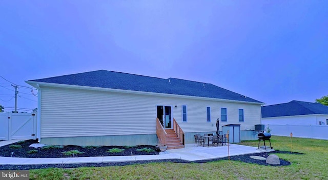 back of property featuring a yard and a patio area