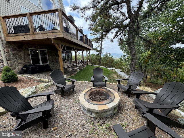 view of patio with an outdoor fire pit and a wooden deck