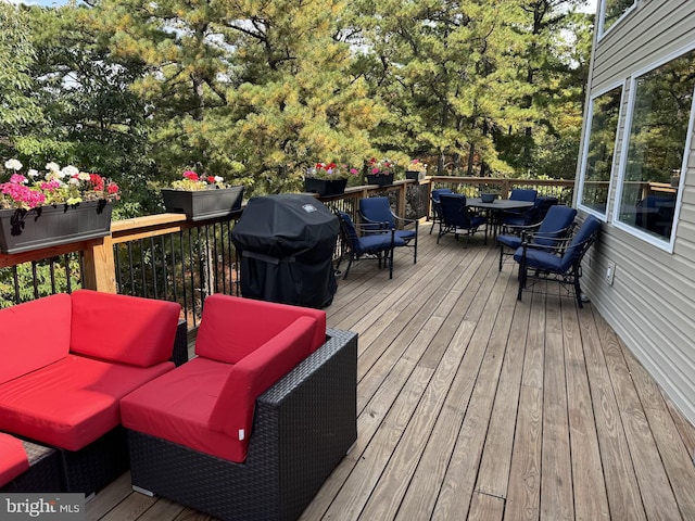 wooden deck with a grill and an outdoor living space