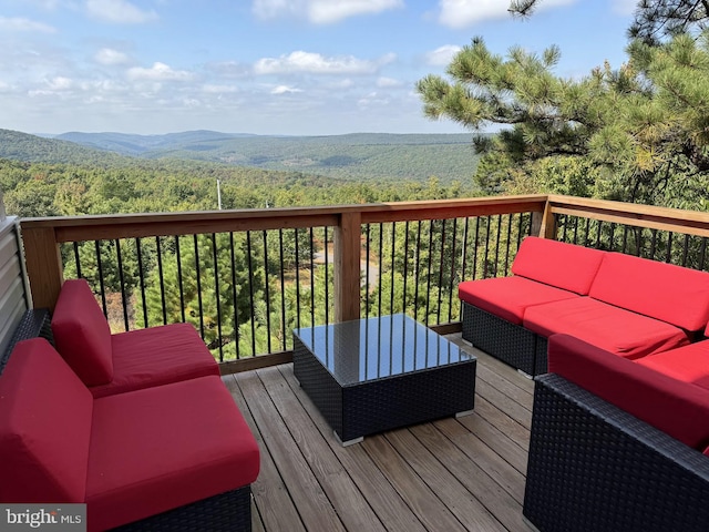 deck with a mountain view and an outdoor hangout area