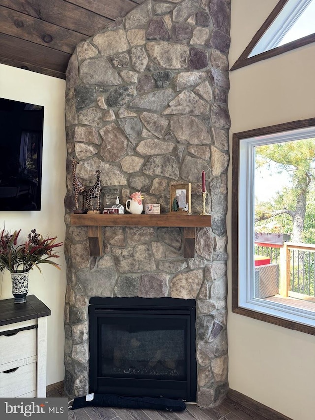 interior details with hardwood / wood-style floors and a stone fireplace