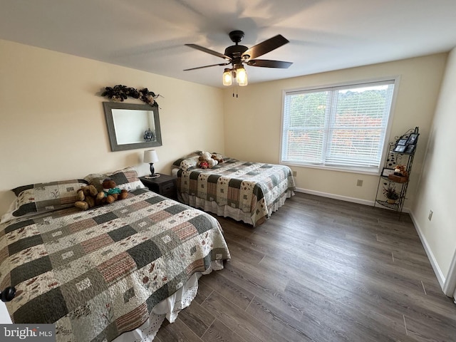 bedroom with dark hardwood / wood-style floors and ceiling fan