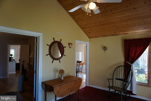 living area with ceiling fan, dark wood-type flooring, wood ceiling, and vaulted ceiling