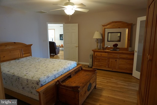 bedroom with ceiling fan and light hardwood / wood-style flooring