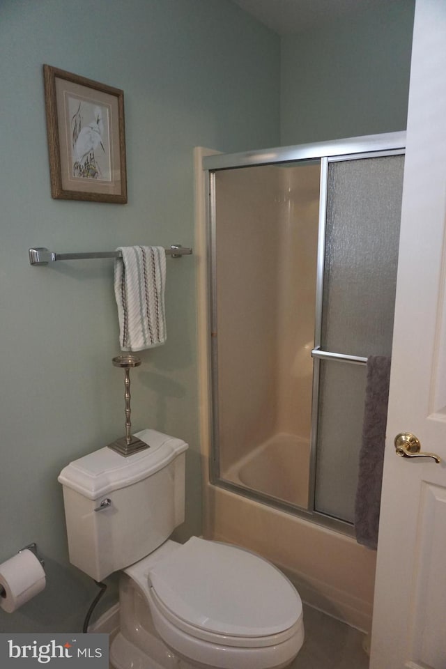 bathroom with shower / bath combination with glass door and toilet