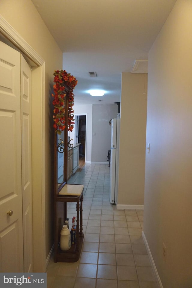 hallway with light tile patterned floors