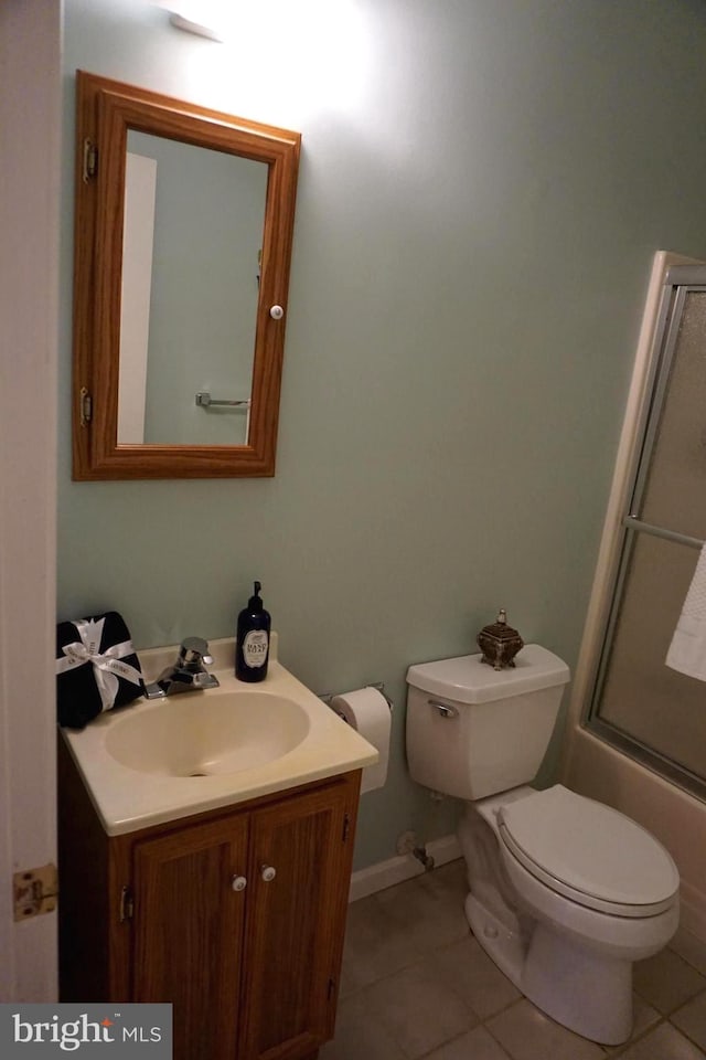 full bathroom with tile patterned flooring, vanity, toilet, and shower / bath combination with glass door