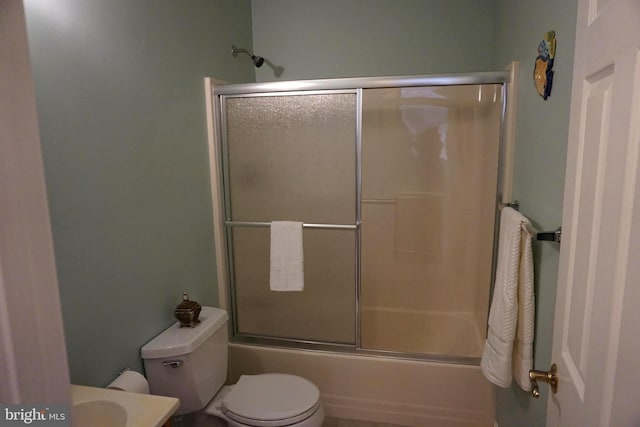 full bathroom with vanity, toilet, and bath / shower combo with glass door