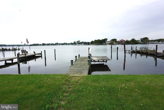 dock area featuring a yard and a water view