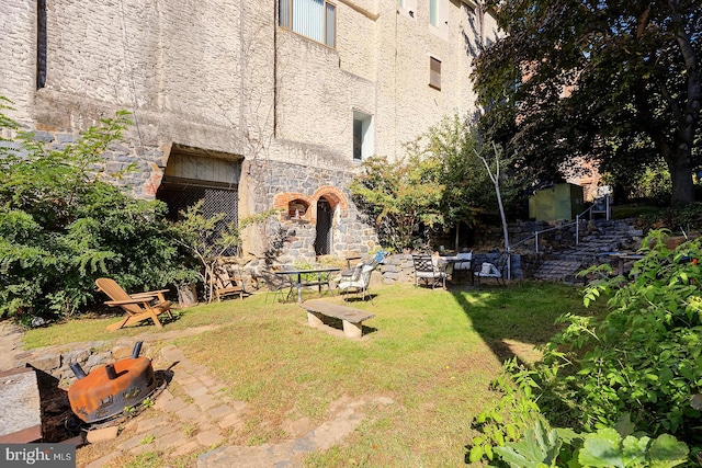 view of yard with an outdoor fire pit and a patio area