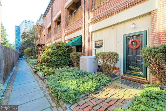 view of exterior entry with a balcony