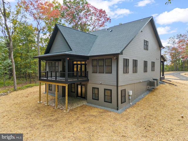 back of house with central air condition unit