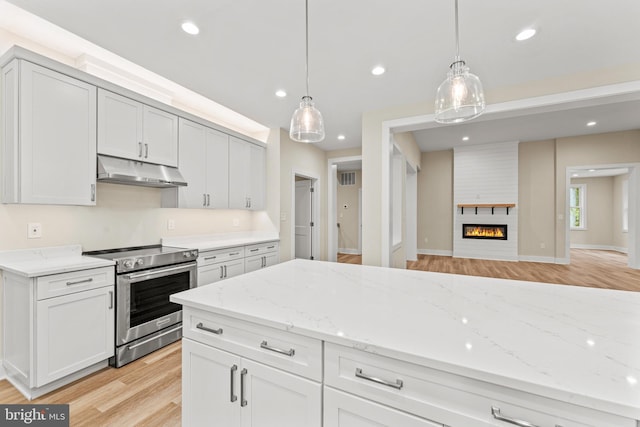 kitchen with white cabinetry, light hardwood / wood-style floors, pendant lighting, and stainless steel electric range oven