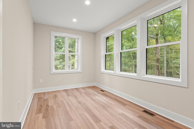 unfurnished room featuring light hardwood / wood-style floors