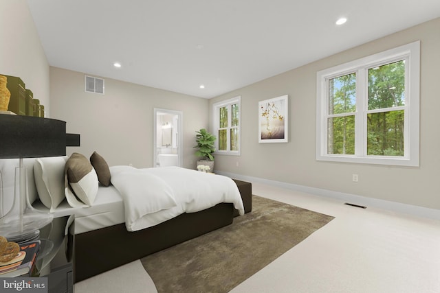 carpeted bedroom featuring connected bathroom