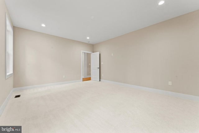 unfurnished room with light carpet