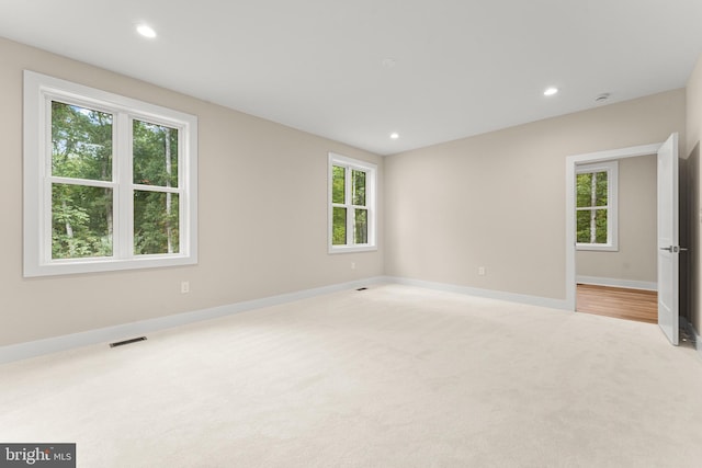 carpeted empty room featuring a healthy amount of sunlight