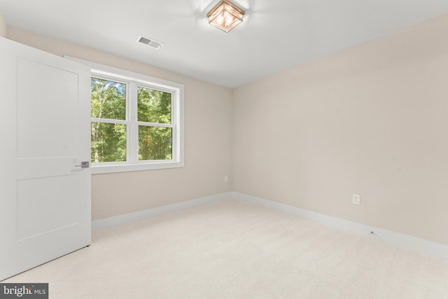 empty room featuring light colored carpet