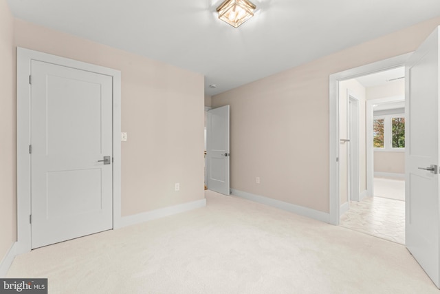 unfurnished bedroom featuring light colored carpet